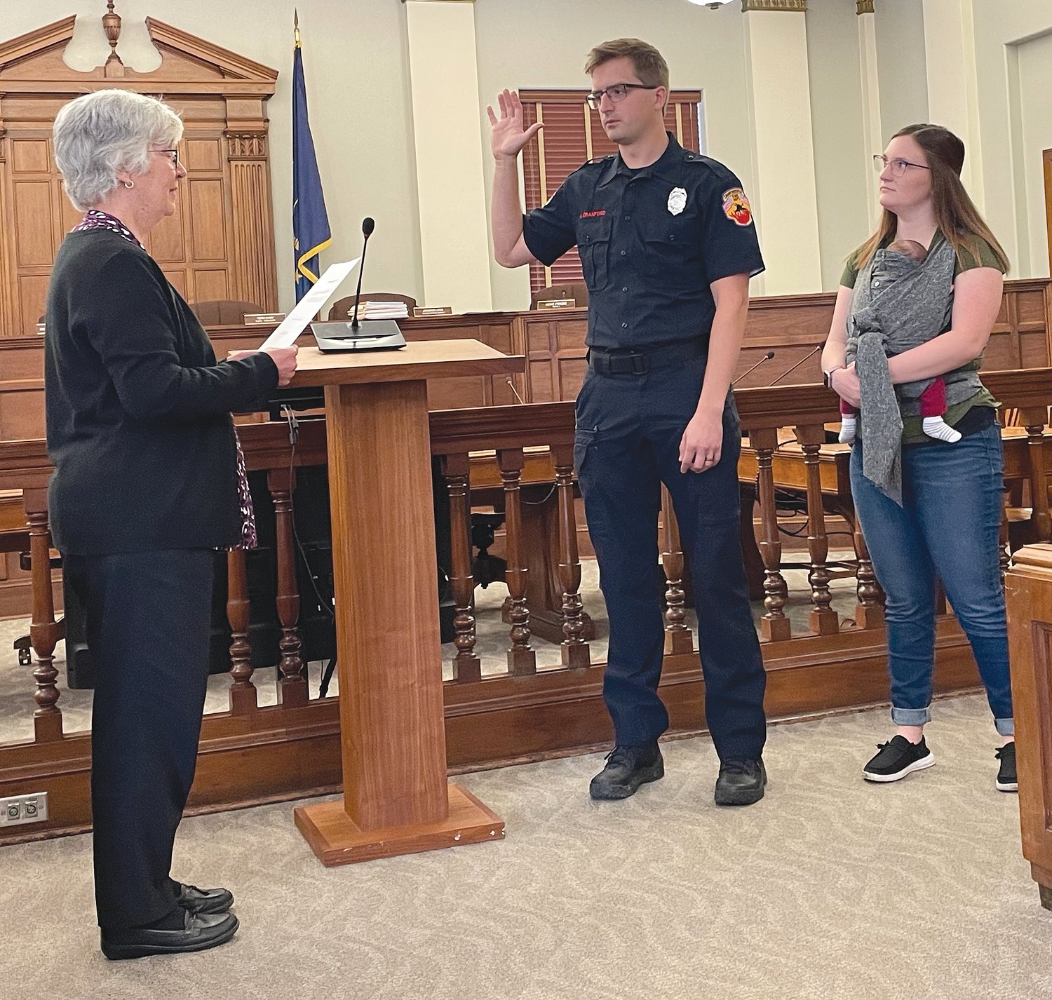 Crawfordsville City Clerk-Treasurer Terri Gadd, left, administers the oath of office Wednesday to the city's newest firefighter, Jacob Cranford. He was joined by his wife and child. He was joined by his wife and child in the city council chambers for the ceremony.